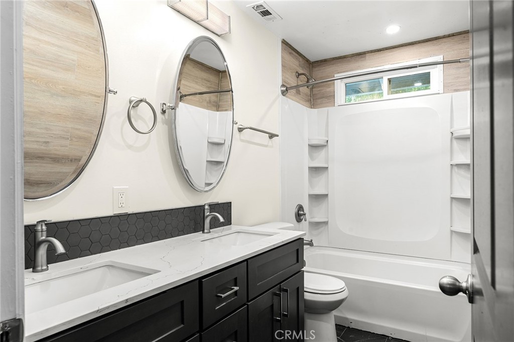 1131 Stewart Avenue Chico, CA 95926 - Photo 14 of 50 a bathroom with a sink a toilet and a mirror