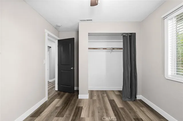 a view of a room with wooden floor and a window