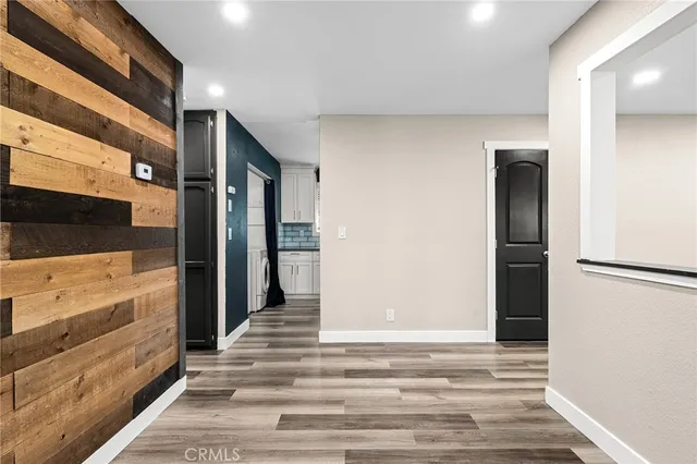 a view of a hallway with closet and mirror