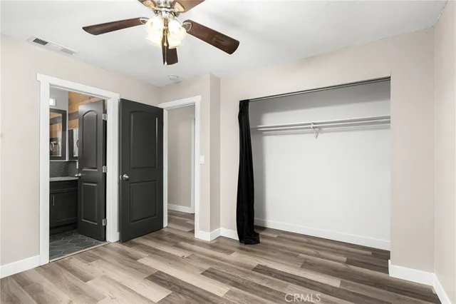 a view of a room with a ceiling fan