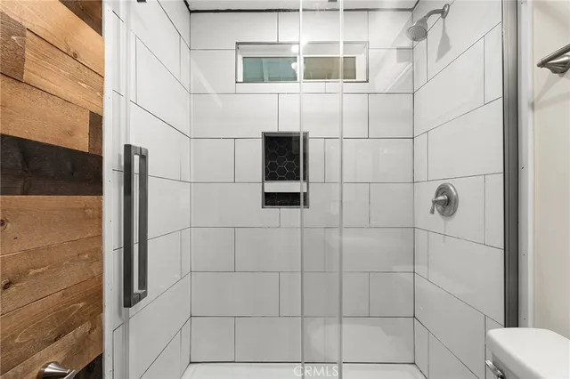 a bathroom with a shower and mirror