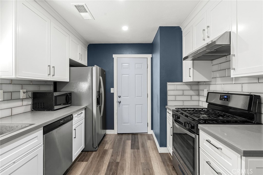 1131 Stewart Avenue Chico, CA 95926 - Photo 9 of 50 a kitchen with stainless steel appliances a refrigerator a sink a stove and cabinets
