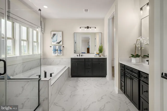a spacious bathroom with a tub sink and mirror