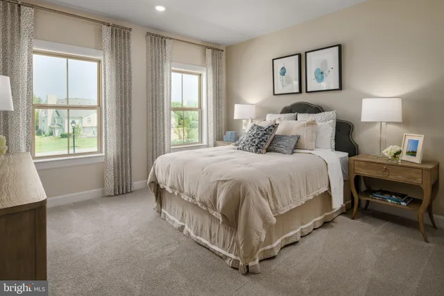 a spacious bedroom with a bed and a window