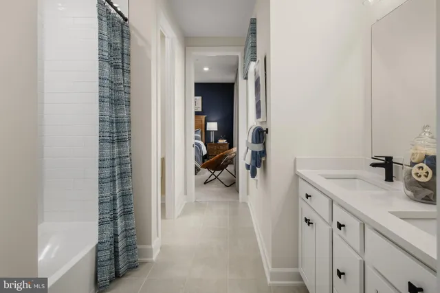 a en suite bathroom with a sink a mirror and a shower
