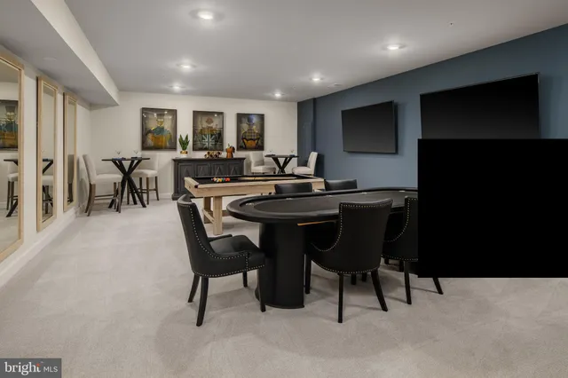 a dining room with a table chairs and a flat screen tv