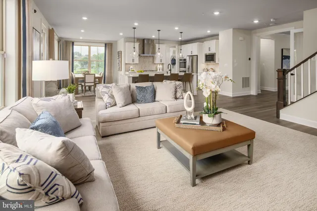 a living room with furniture kitchen and a table