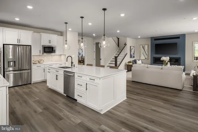 a kitchen with a sink stainless steel appliances and window