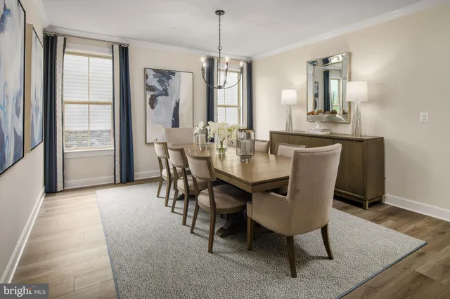 a view of a a dining room with furniture window and wooden floor