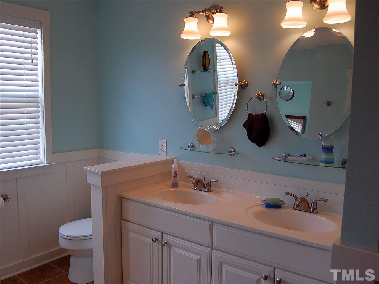 1108 Garnet Ridge Way Raleigh, NC 27607 - Photo 3 of 4 a bathroom with a toilet sink and mirror
