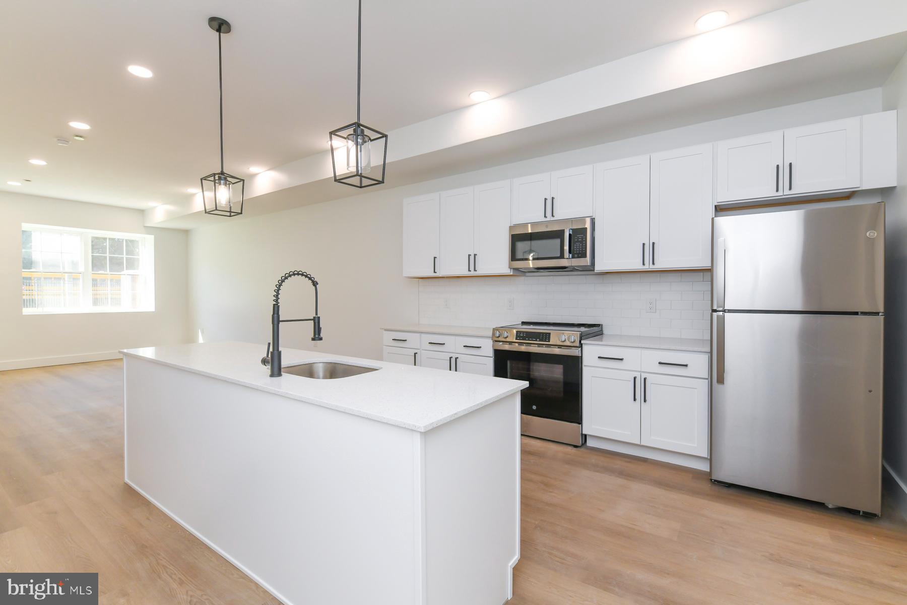 100 Aura Road, Unit 110 Clayton, NJ 08312 - Photo 19 of 34 a kitchen with stainless steel appliances granite countertop a refrigerator a sink dishwasher a stove and a refrigerator
