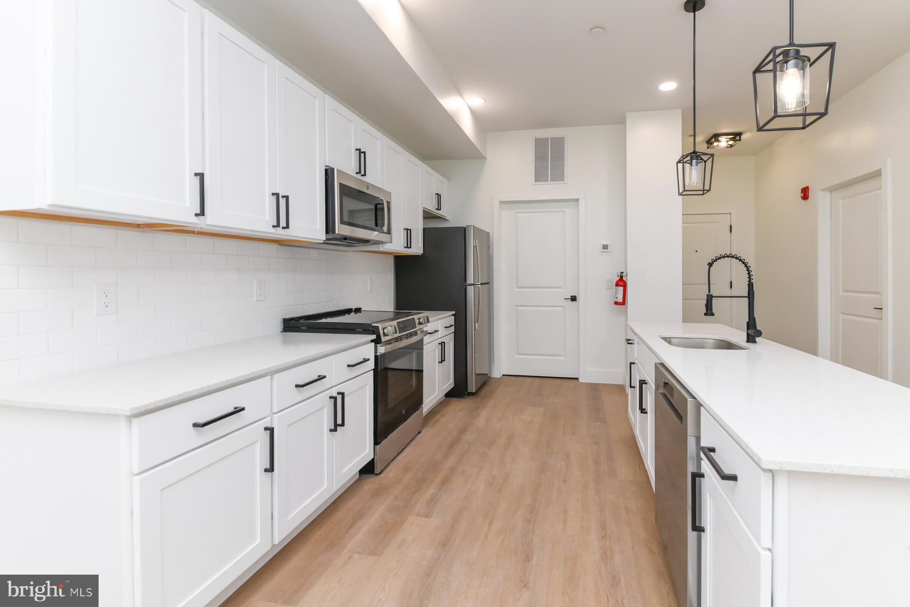 100 Aura Road, Unit 110 Clayton, NJ 08312 - Photo 21 of 34 a kitchen with stainless steel appliances a sink stove and refrigerator