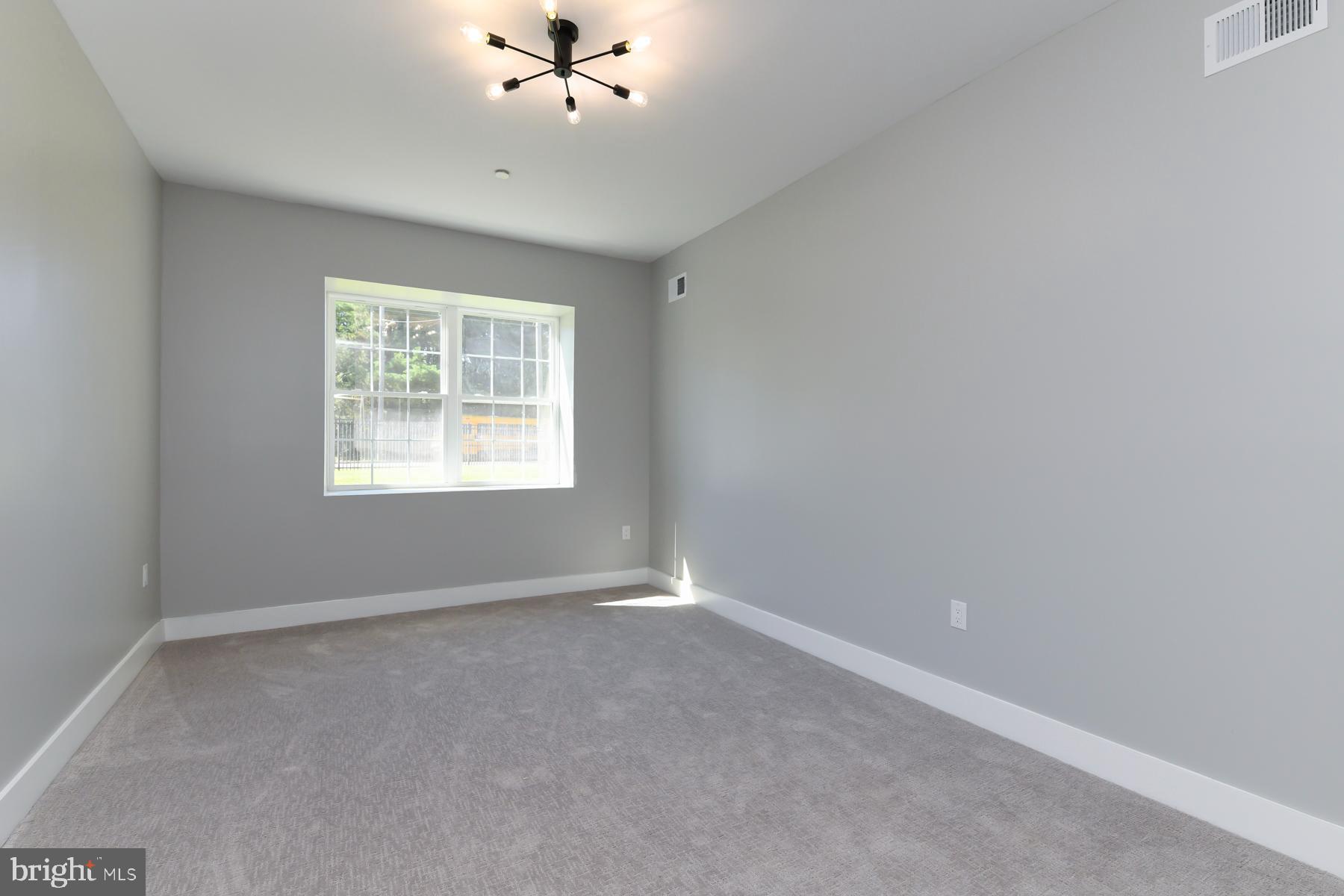 100 Aura Road, Unit 110 Clayton, NJ 08312 - Photo 28 of 34 an empty room with windows and fan