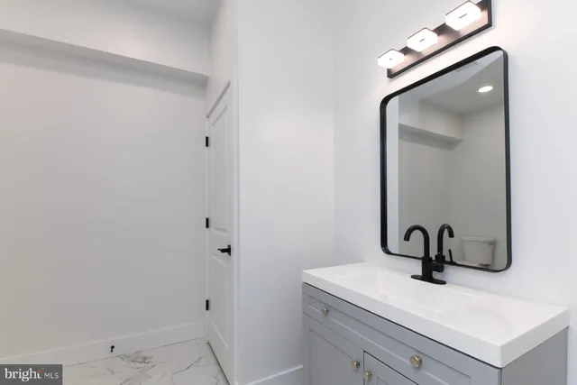 a kitchen with stainless steel appliances white cabinets and a refrigerator