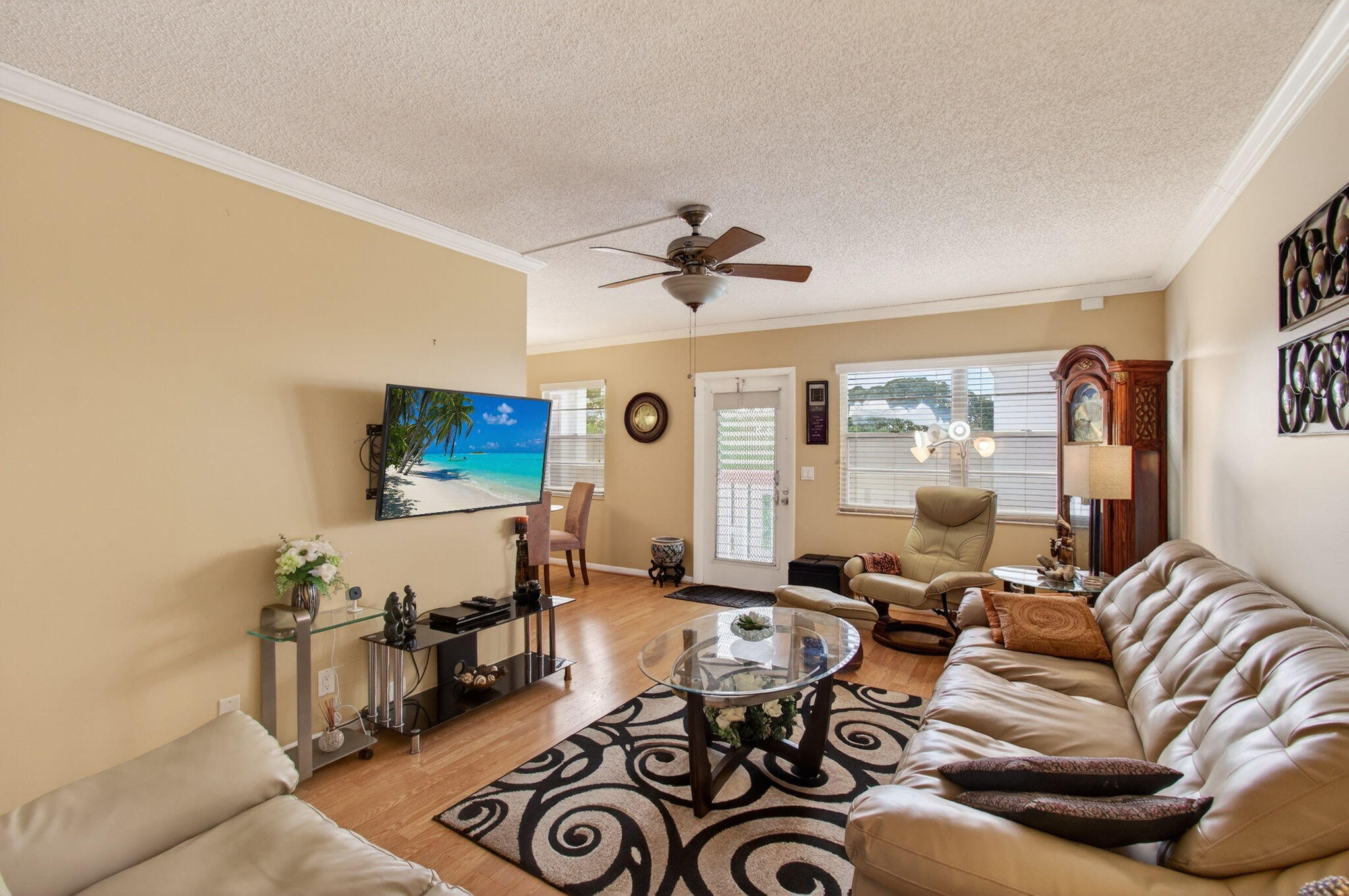 4082 Wolverton East Boca Raton, FL 33434 - Photo 10 of 93 a living room with furniture a clock and a flat screen tv