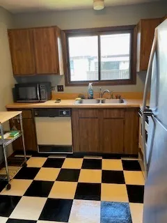 a kitchen with a black and white checkered floor with a black white checkered floor