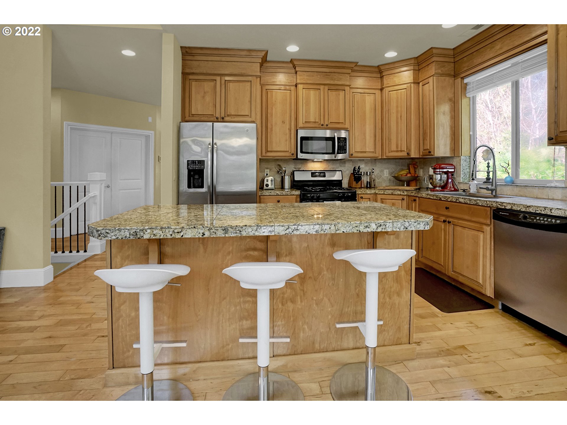 11 Big Tree Road Gleneden Beach, OR 97388 - Photo 10 of 32 a kitchen with stainless steel appliances granite countertop a sink a stove top oven a dining table and chairs