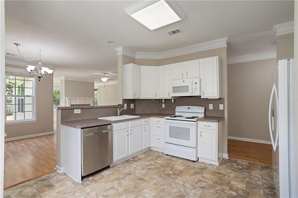 17 Williams Pride Way Newnan, GA 30265 - Photo 14 of 28 a kitchen with a stove sink and cabinets