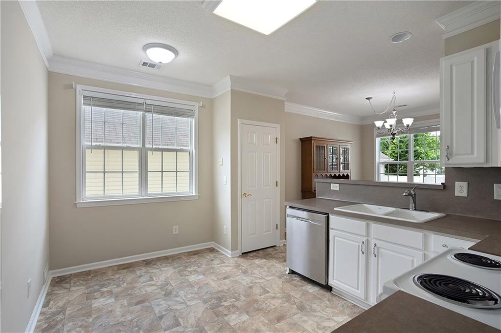 17 Williams Pride Way Newnan, GA 30265 - Photo 16 of 28 a kitchen with a sink stove and cabinets
