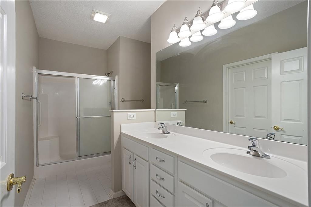 17 Williams Pride Way Newnan, GA 30265 - Photo 20 of 28 a bathroom with a double vanity sink mirror and shower