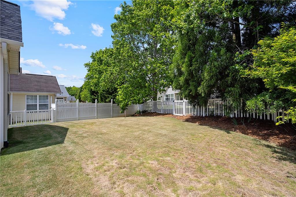 17 Williams Pride Way Newnan, GA 30265 - Photo 24 of 28 a backyard of a house with yard and trampoline