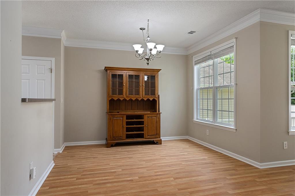 17 Williams Pride Way Newnan, GA 30265 - Photo 4 of 28 wooden floor in an empty room with a window