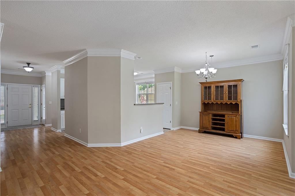 17 Williams Pride Way Newnan, GA 30265 - Photo 6 of 28 a view of an empty room with window and wooden floor