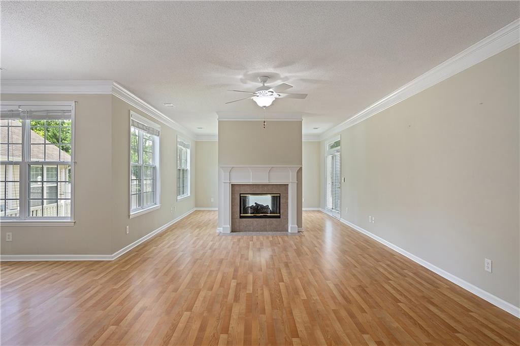 17 Williams Pride Way Newnan, GA 30265 - Photo 7 of 28 wooden floor fireplace and windows in an empty room