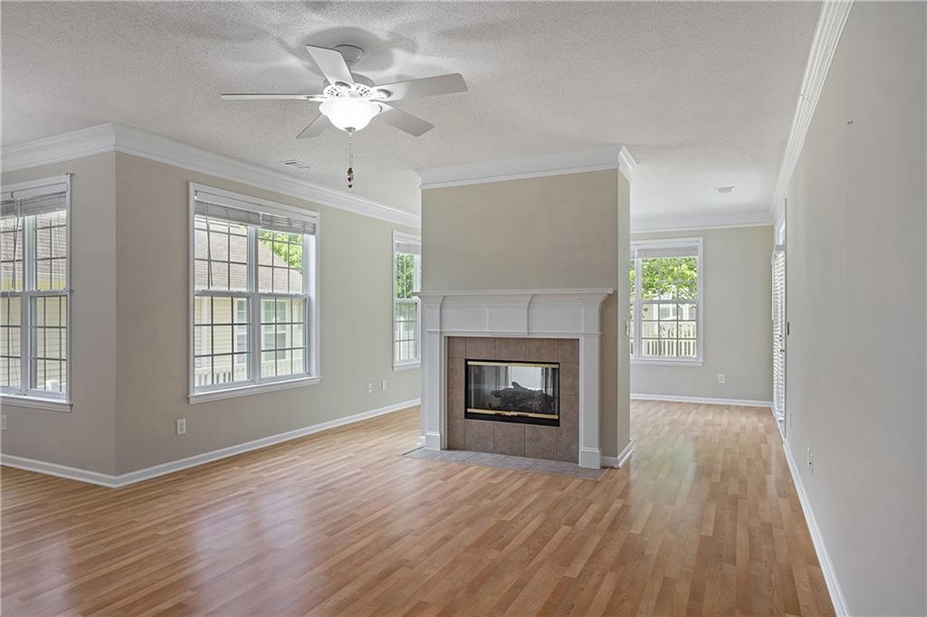 17 Williams Pride Way Newnan, GA 30265 - Photo 8 of 28 wooden floor fireplace and windows in an empty room