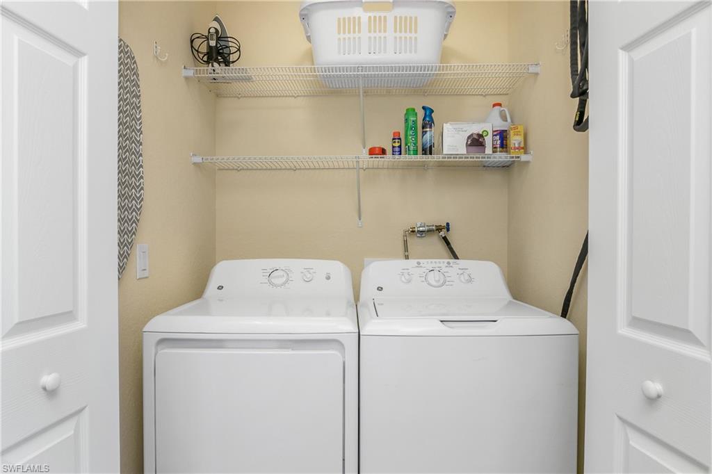 9834 Giaveno Circle, Unit 1746 Naples, FL 34113 - Photo 15 of 41 a utility room with dryer and washer