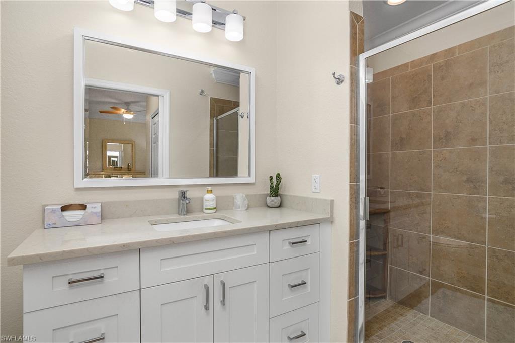 9834 Giaveno Circle, Unit 1746 Naples, FL 34113 - Photo 18 of 41 a bathroom with a double vanity sink mirror and