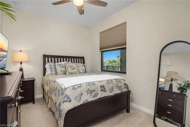 a bedroom with a bed and a lamp on dresser