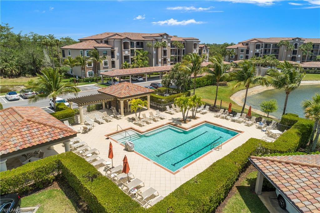 9834 Giaveno Circle, Unit 1746 Naples, FL 34113 - Photo 23 of 41 an aerial view of a house with a garden and lake view