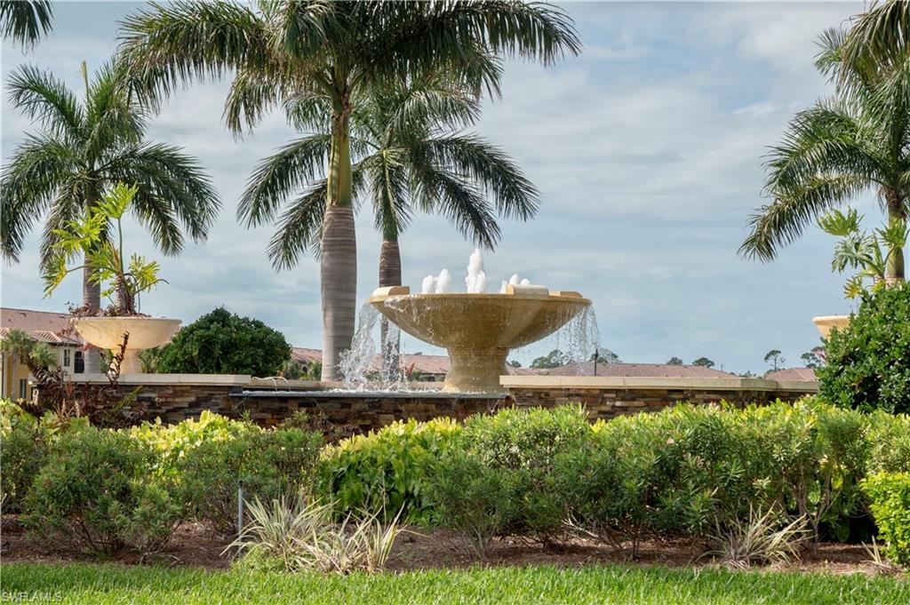 9834 Giaveno Circle, Unit 1746 Naples, FL 34113 - Photo 27 of 41 a couple of palm trees sitting in a yard with swimming pool