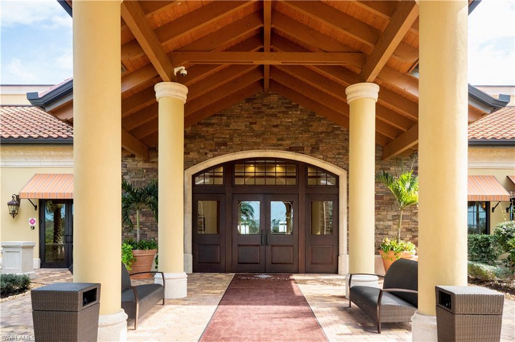 9834 Giaveno Circle, Unit 1746 Naples, FL 34113 - Photo 32 of 41 a front view of a house with a yard