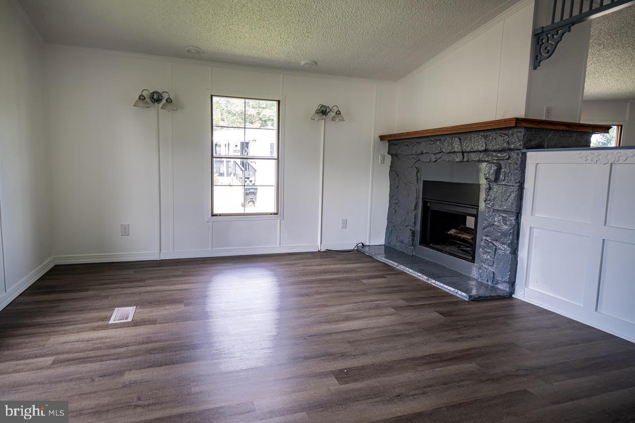 35 Bonneau Heights Road Gettysburg, PA 17325 - Photo 8 of 34 an empty room with wooden floor fireplace and windows