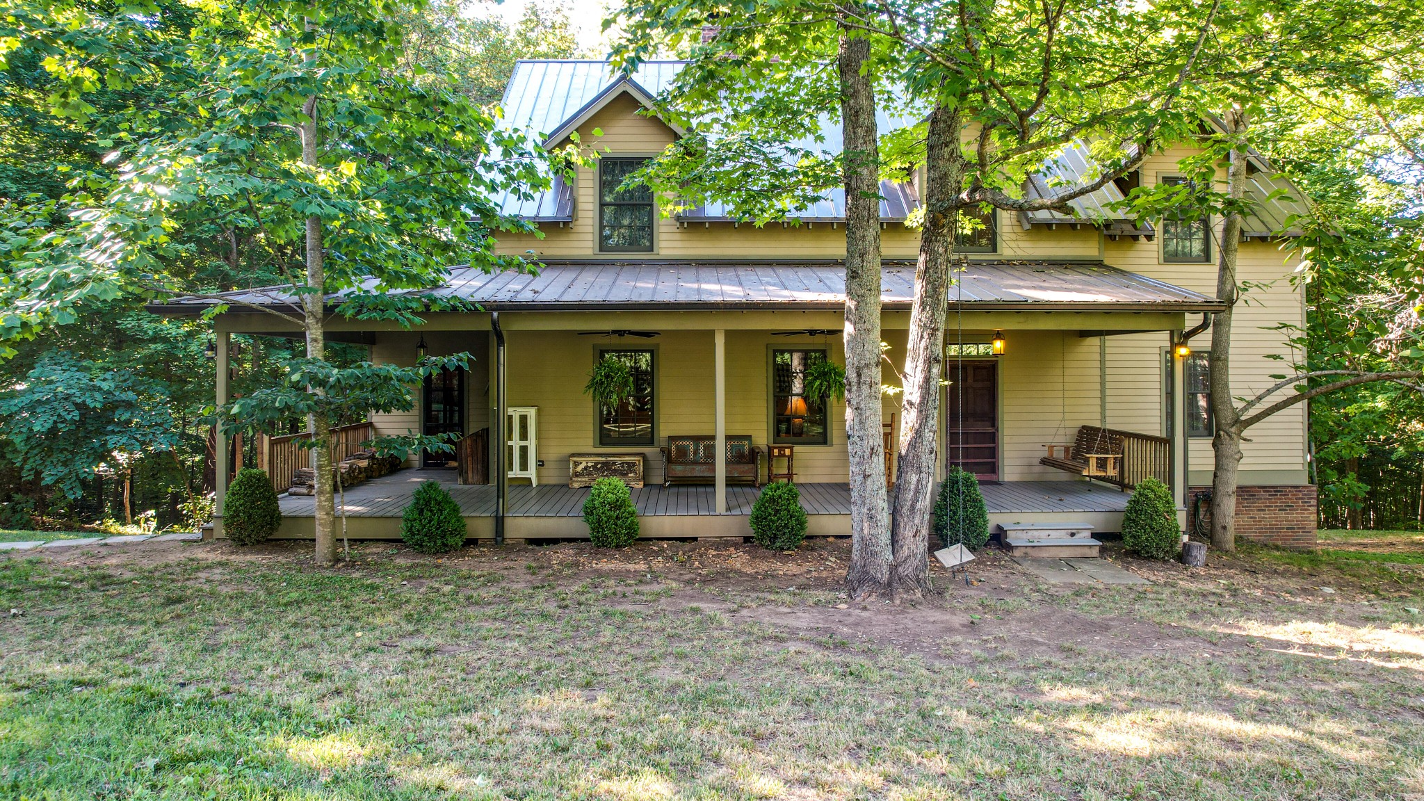 a view of a house with backyard porch and sitting area
