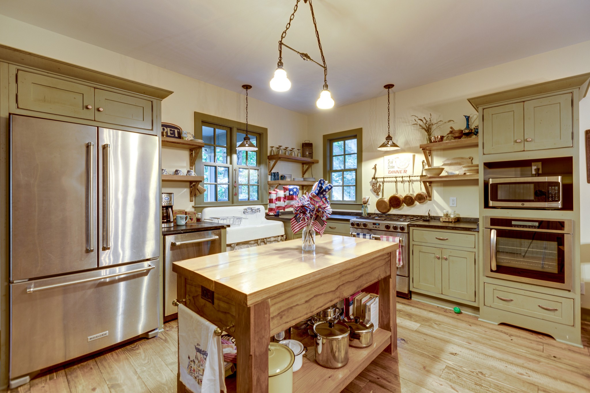 5184 Fire Tower Road Franklin, TN 37064 - Photo 21 of 53 a kitchen with a refrigerator a sink dishwasher and a stove with wooden floor