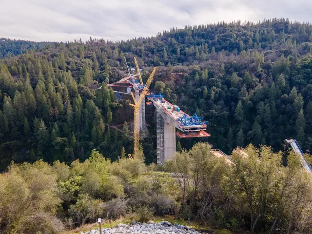 a view of a house with a yard and mountain