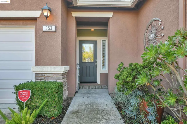 a view of a door of the house with potted plants