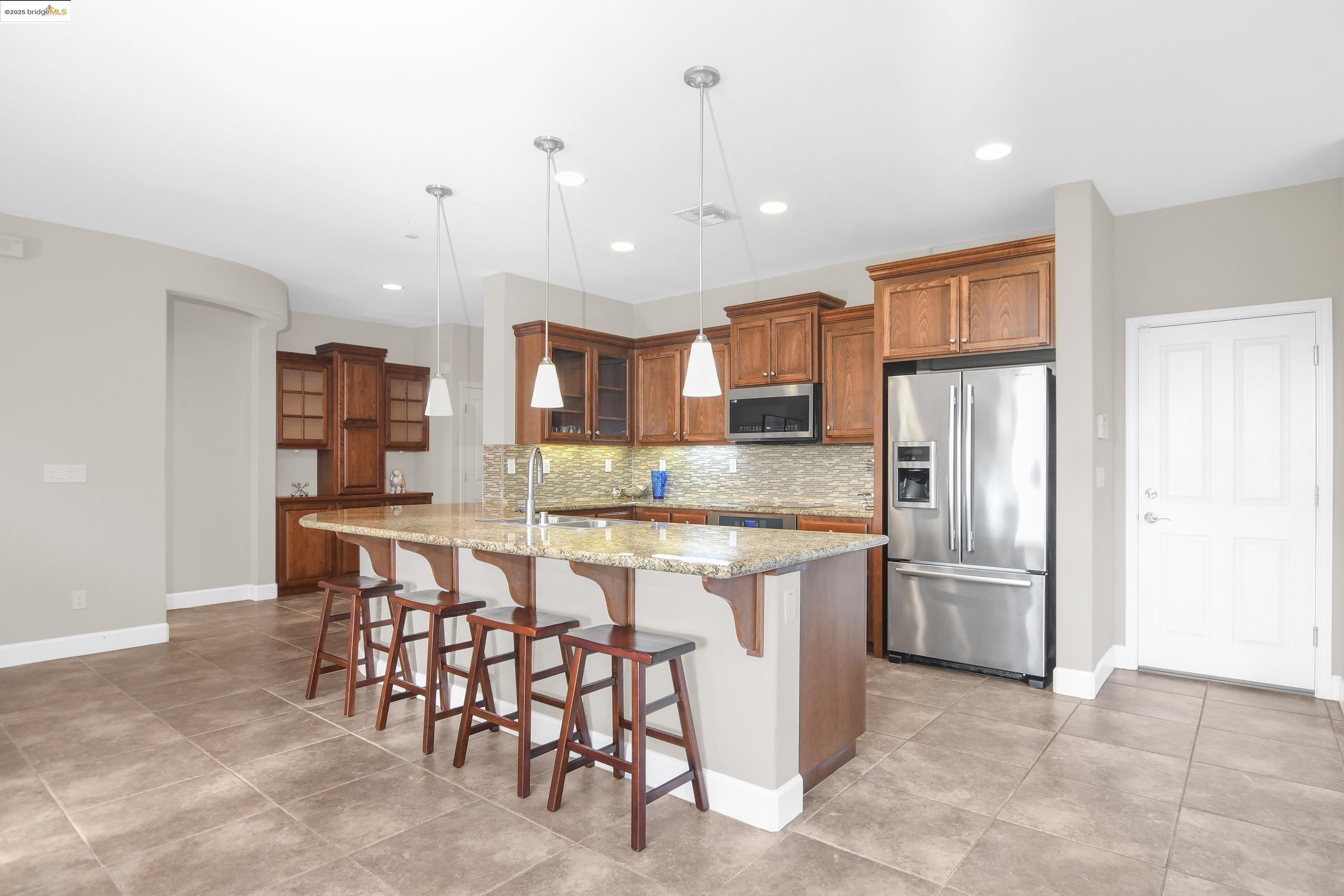 353 Desert Forest Court Rio Vista, CA 94571 - Photo 17 of 39 a kitchen with stainless steel appliances granite countertop a stove and a refrigerator
