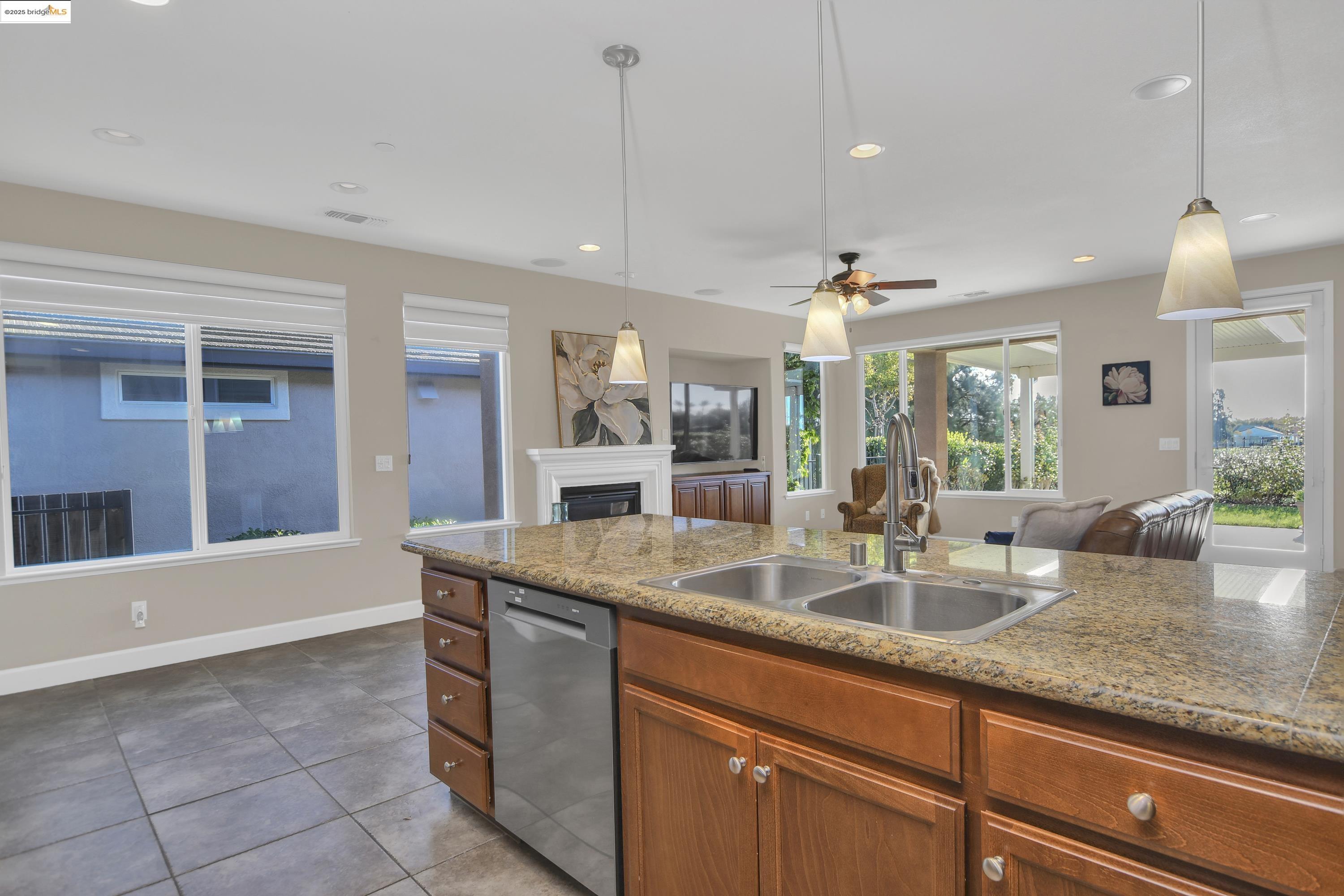 353 Desert Forest Court Rio Vista, CA 94571 - Photo 19 of 39 a kitchen with granite countertop a sink and white cabinets