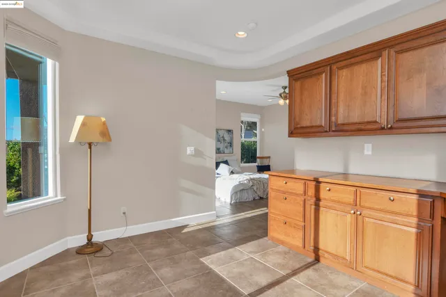 a bedroom with a large bed and a chandelier