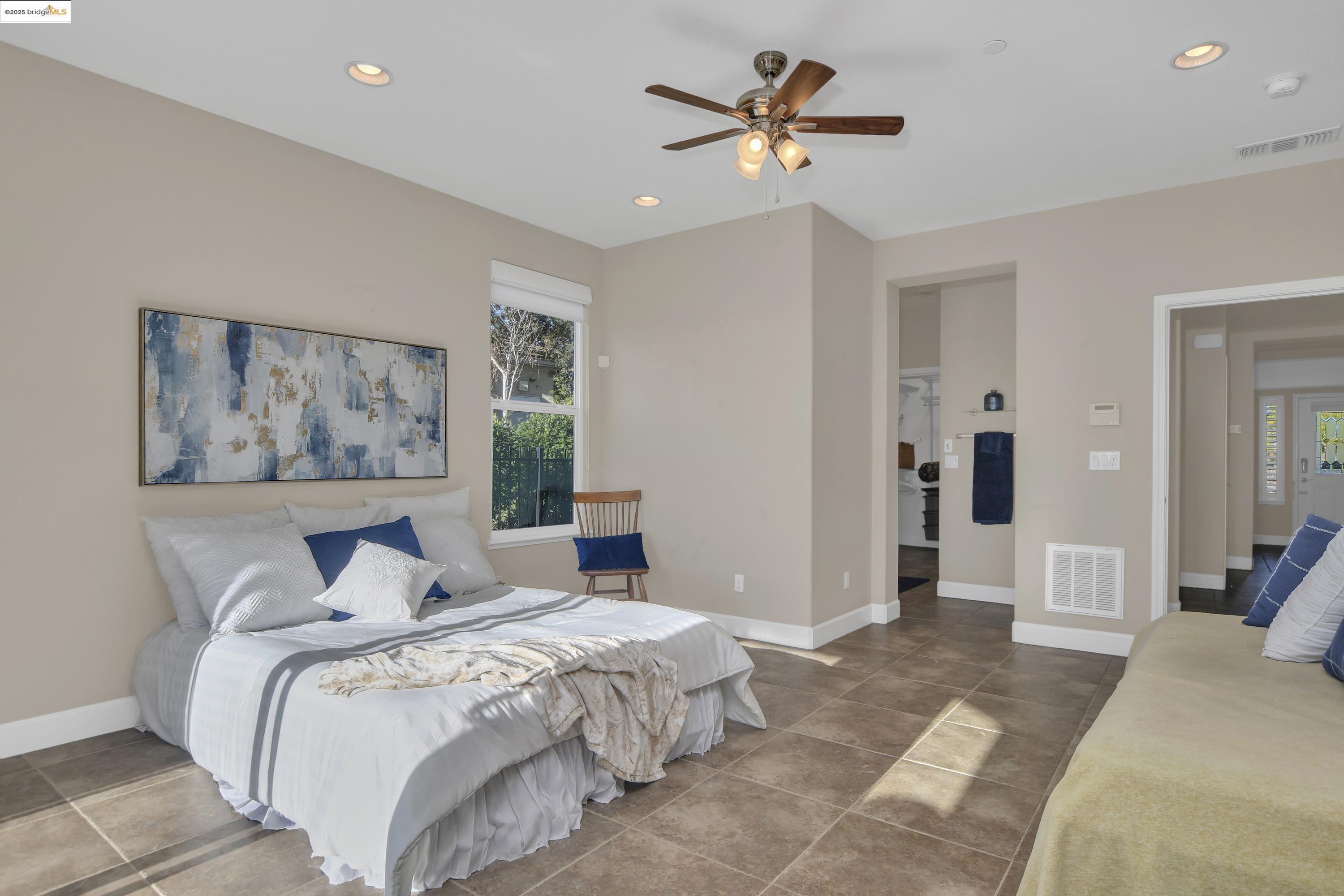 353 Desert Forest Court Rio Vista, CA 94571 - Photo 27 of 39 a bedroom with a large bed and a chandelier