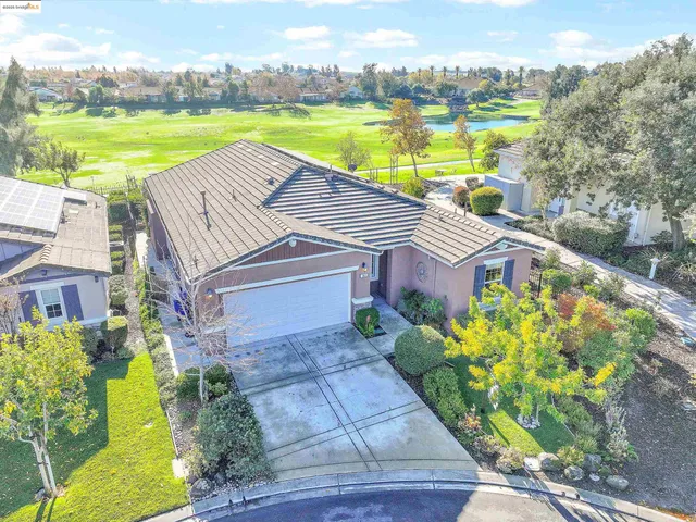 a aerial view of a house with a big yard and potted plants