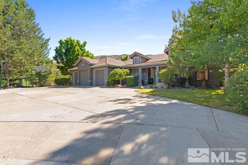 3521 South Cheechako Circle Reno, NV 89519 - Photo 2 of 40 a front view of a house with a garden