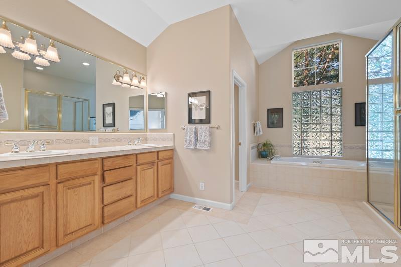 3521 South Cheechako Circle Reno, NV 89519 - Photo 22 of 40 a spacious bathroom with a granite countertop sink mirror and bathtub
