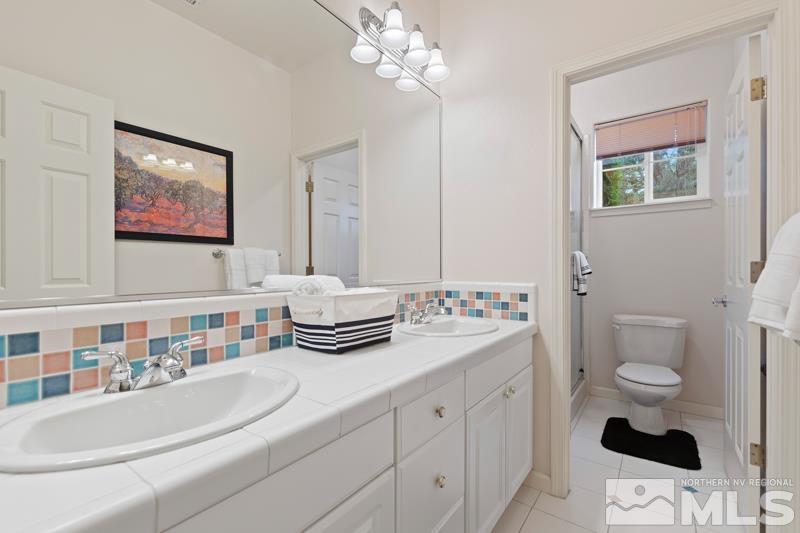 3521 South Cheechako Circle Reno, NV 89519 - Photo 31 of 40 a bathroom with a sink and a mirror
