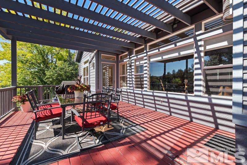 3521 South Cheechako Circle Reno, NV 89519 - Photo 32 of 40 a view of a patio with table and chairs next to a yard