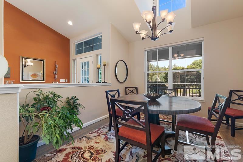 3521 South Cheechako Circle Reno, NV 89519 - Photo 7 of 40 a dining room with furniture a potted plant and a chandelier
